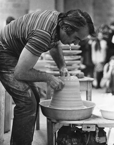 Artist Peter Voulkos demonstrating lifting clay for a class at the University of Kentucky. John Tuska was in attendance