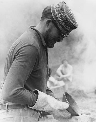John Tuska examining a clay vessel after a raku firing