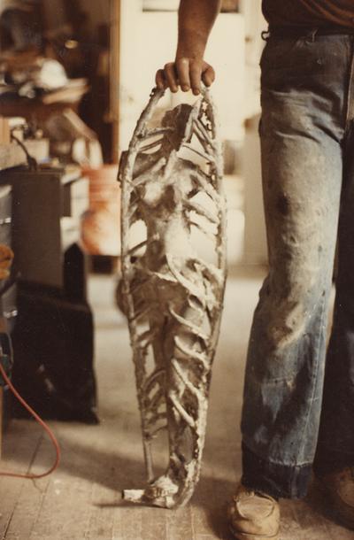 John Tuska in his studio with a sculpture that has the spews still attached. The photograph was taken by Ted Bronda