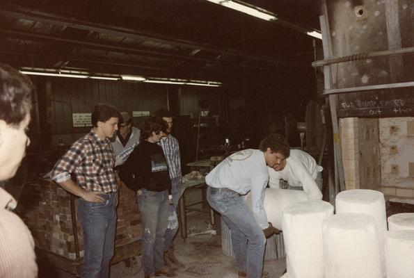 John Tuska and six students moving molds in the University of Kentucky foundry. The photograph was taken by Zig Gierlach