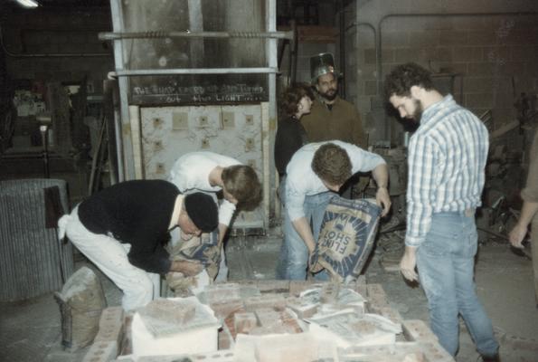 Jack Gron and six students preparing molds for a pour in the University of Kentucky foundry. The photograph was taken by Zig Gierlach