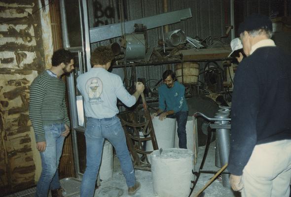 Five students moving molds in the University of Kentucky foundry. The photograph was taken by Zig Gierlach