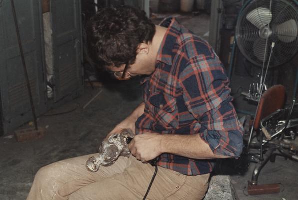 An unidentified student finishing a sculpture in the University of Kentucky foundry. The photograph was taken by Zig Gierlach