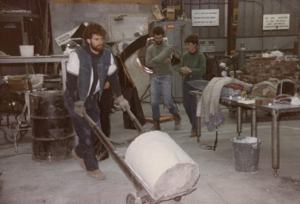 Four students moving molds in the University of Kentucky foundry. The photograph was taken by Zig Gierlach