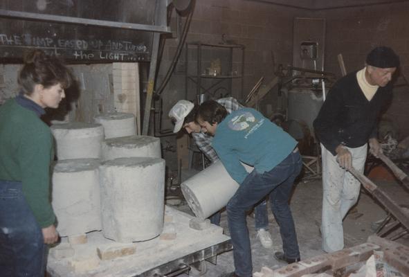 Four students moving molds in the University of Kentucky foundry. The photograph was taken by Zig Gierlach