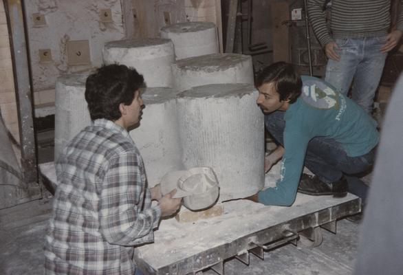 Three students moving molds in the University of Kentucky foundry. The photograph was taken by Zig Gierlach