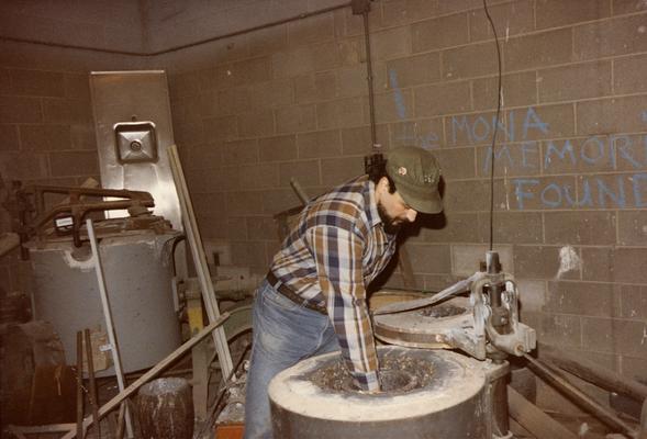 Jack Gron working with the furnace in the University of Kentucky foundry. The photograph was taken by Zig Gierlach