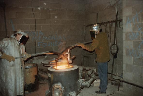 Jack Gron and John Tuska working with the furnace in the University of Kentucky foundry. The photograph was taken by Zig Gierlach