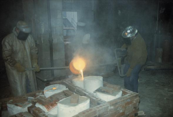 Jack Gron and John Tuska pouring molten metal in the University of Kentucky foundry. The photograph was taken by Zig Gierlach