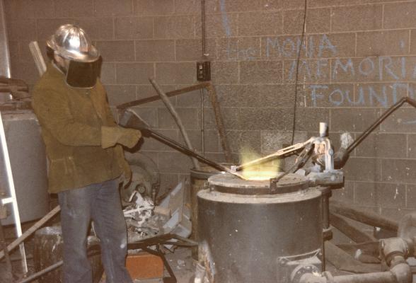 Jack Gron working with the furnace in the University of Kentucky foundry. The photograph was taken by Zig Gierlach