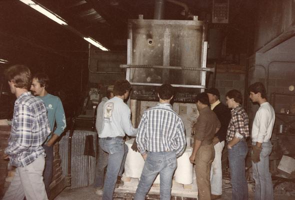 John Tuska and eight unidentified students standing in the University of Kentucky foundry. The photograph was taken by Zig Gierlach