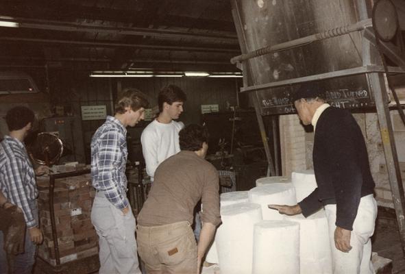 Five unidentified students preparing to move some molds in the University of Kentucky foundry. The photograph was taken by Zig Gierlach