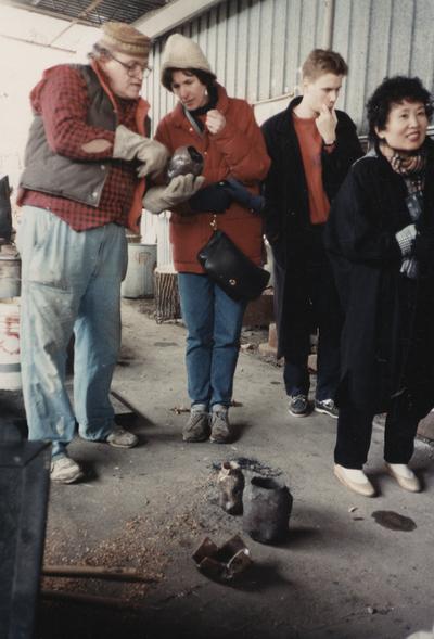 John Tuska and three unidentified students at a raku firing