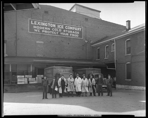 Lexington Cold Storage Plant, Swift & Company (wholesale dairy, cream; 412-414 West Short); men standing in front of trucks, exterior of building