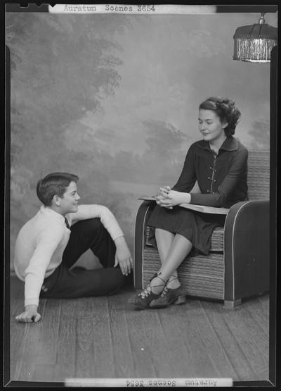 Henry Clay High School (701 East Main) Aurataim Scenes; woman sitting in chair reading to child that is sitting on the floor