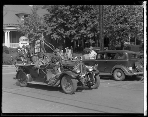 University of Kentucky May Day: float in parade, three women sticking their heads out of a cardboard crown