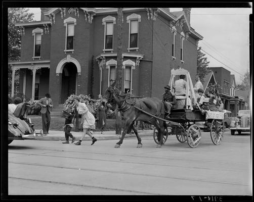 University of Kentucky May Day; float in parade, girls sitting on truck wearing dresses