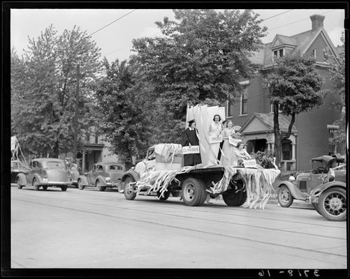 University of Kentucky May Day; float in parade, female students holding signs