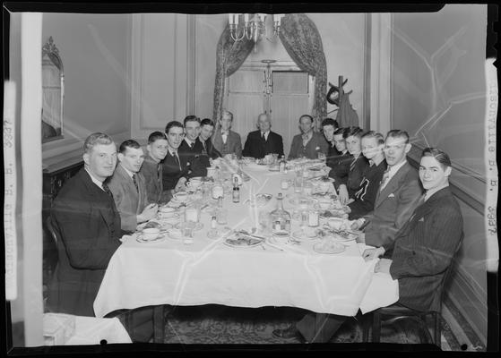 Madisonville Basketball Team; banquet, men sitting at dinner table