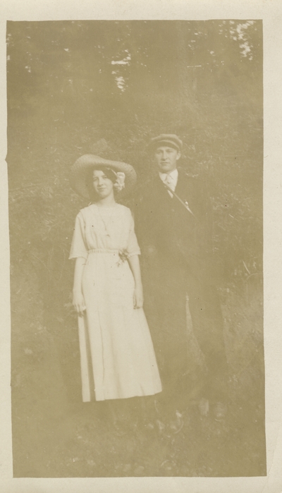 a man and woman standing together outside