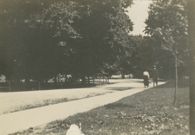 a woman and man walking along a path