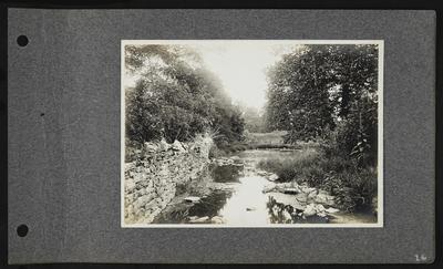 Bend in river, stone walled bank on left