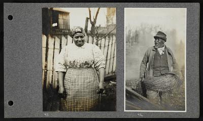 Laughing woman, wearing head wrap, patterned blouse, and apron, fencing behind her