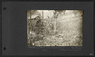 Log cabin and mill on left, brushy area with fallen trees, bluffs in background, caption                          Bill Meese's Mill - on the Cumberland- near Hermitage