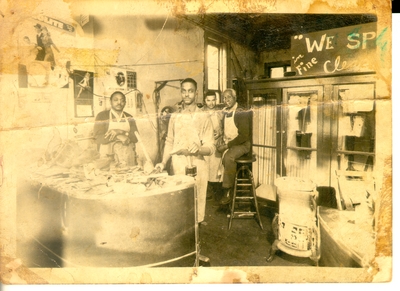 Ben F. Spencer Jr., in the shoe shop, seated on the stool. Original and reproduction