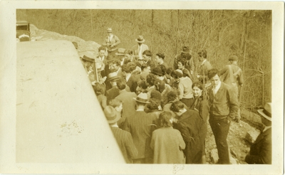 Crowd of students around bus. 