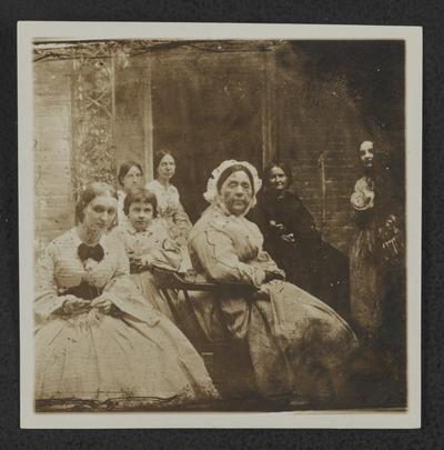 Woman and a young girl seated on a patio at John S. Wilson house on Upper Street