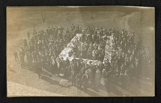 Group, unidentified, standing around a large table