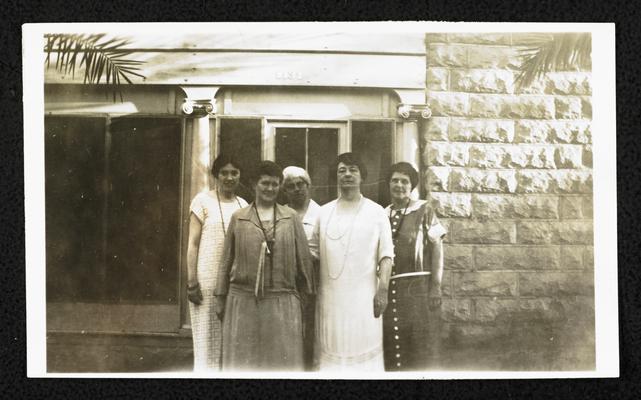 Cora Wilson Stewart and four unidentified females standing in front of a stone building, same building in item #52, same clothes in item #51 and #52