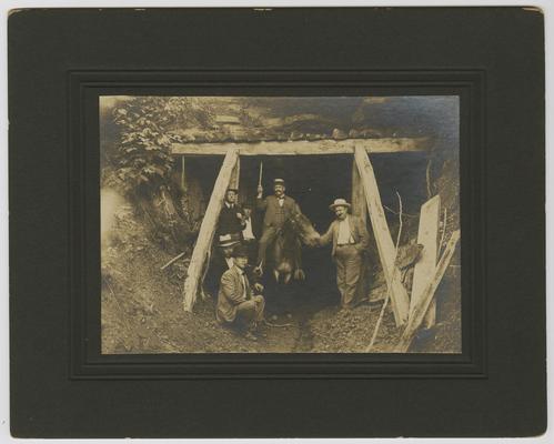 6 unidentified males at the opening of a mine. Back of the photograph reads: Elkhorn County Coal, Dicken County, 8 ft. thick