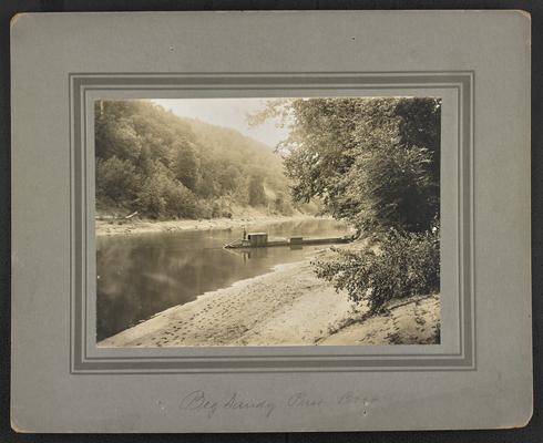 Unidentified male standing on a push boat on a river. Bottom of the photograph reads: Big Sandy Push Boat