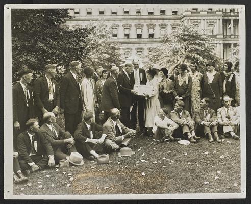 Tennessee students. A label formerly attached to the photograph reads: President Hoover receiving Tennessee Mountain Students at the White House. In addition to their letters written to the President, they bore gifts from the Hills-- A basket of sweet potatoes and some of their handcraft