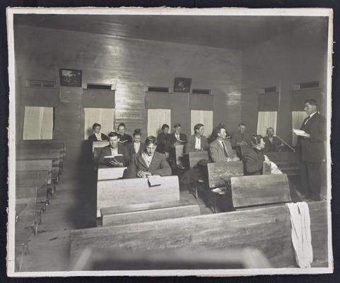 Unidentified adult students, sitting at desks