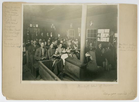 Kentucky students. Back of the picture reads: Illiteracy has been abolished from Clear Fork District, Miss Allie Kiser, teacher, enrollment- 60 pupils, Moonlight School at Munson