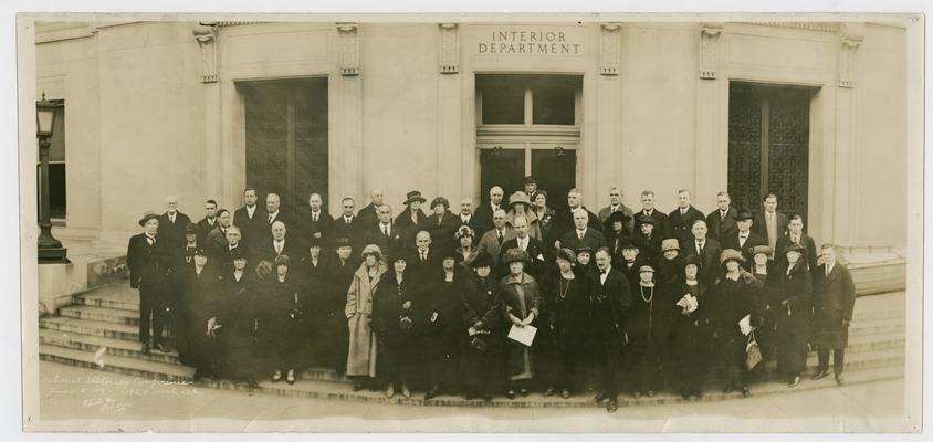 Cora Wilson Stewart and the attendees of the National Illiteracy Conference on January 11-14, 1924 in Washington D.C., posing in fron of the Interior Department