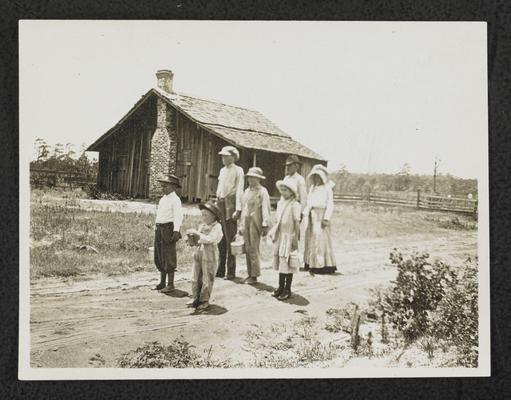 Alabama students. Back of the photograph reads: Eola School, Dale County, Alabama. The whole family in school. The children from 7 am until 3 pm. The parents from 3 pm to 5 pm