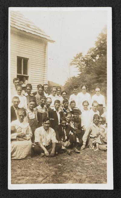 Mr. Sizemore, teacher. This is Mr. Sizemore's moonlight school, he had 32. I could not get them all in the picture. The man with the cross is one of the beginners. He owned & operated the Moonshine still