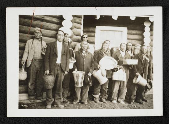 Unidentified group of males holding hand-woven baskets