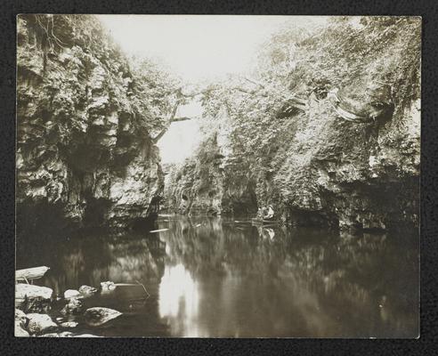 Unidentified man and two women sitting at the Big Sandy River