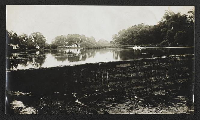 People in a boat in a river behind a damn, back of the photograph reads: Little Miami