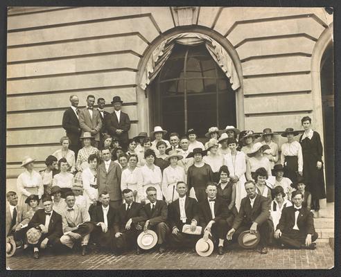 Large group photograph of adult men and women, with Cora Wilson Stewart standing on the second row, just right of center, wearing a black dress