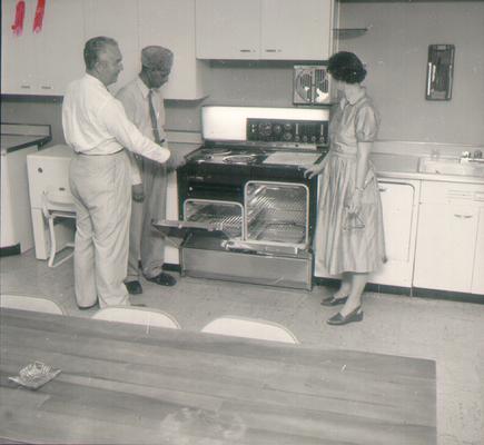 Groups; Unidentified; A group of people looking at a new stove