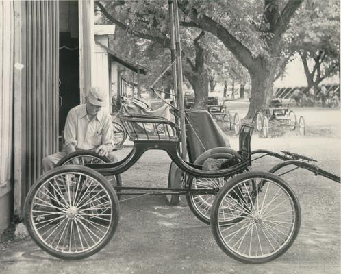 Horses; People Working with Tack and Horse Accessories; A man working on a carriage at the 1953 Horse show