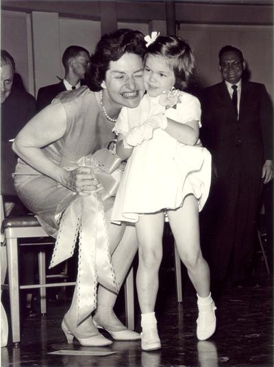 Johnson, Lyndon B. and Ladybird; Ladybird hugs a little girl, May 1964