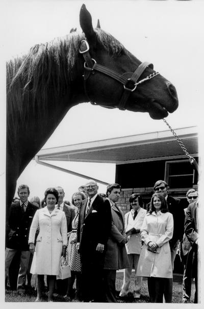 Princess Margaret; 1974; A crowd full of well-known people looking at a large horse