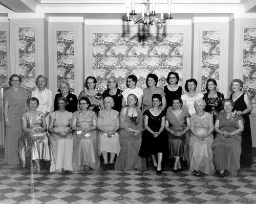 Groups; Unidentified; Twenty women gathered under a chandelier